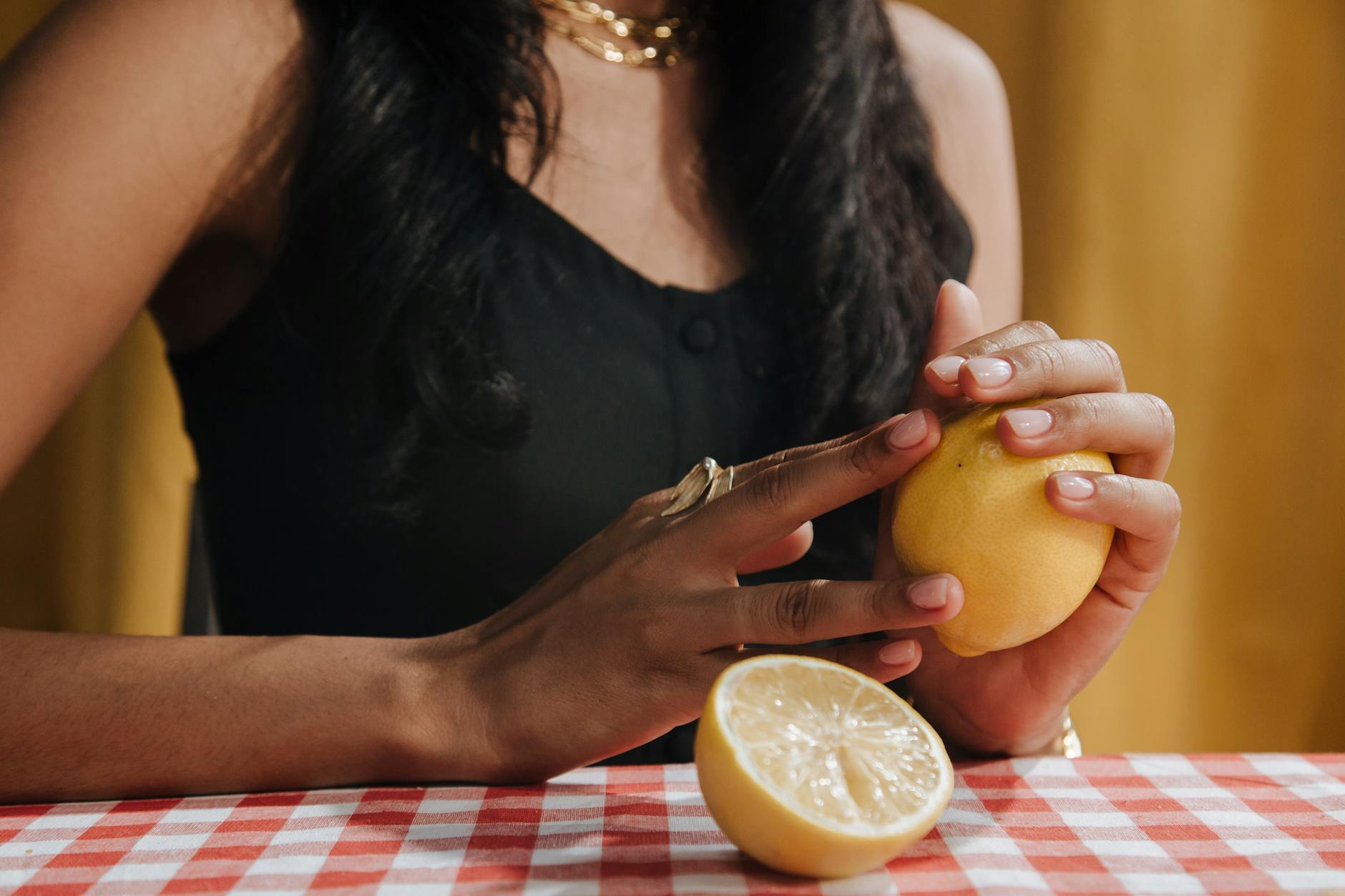 A hand holding a modern vibrator against a minimalistic purple backdrop, showcasing contemporary intimacy