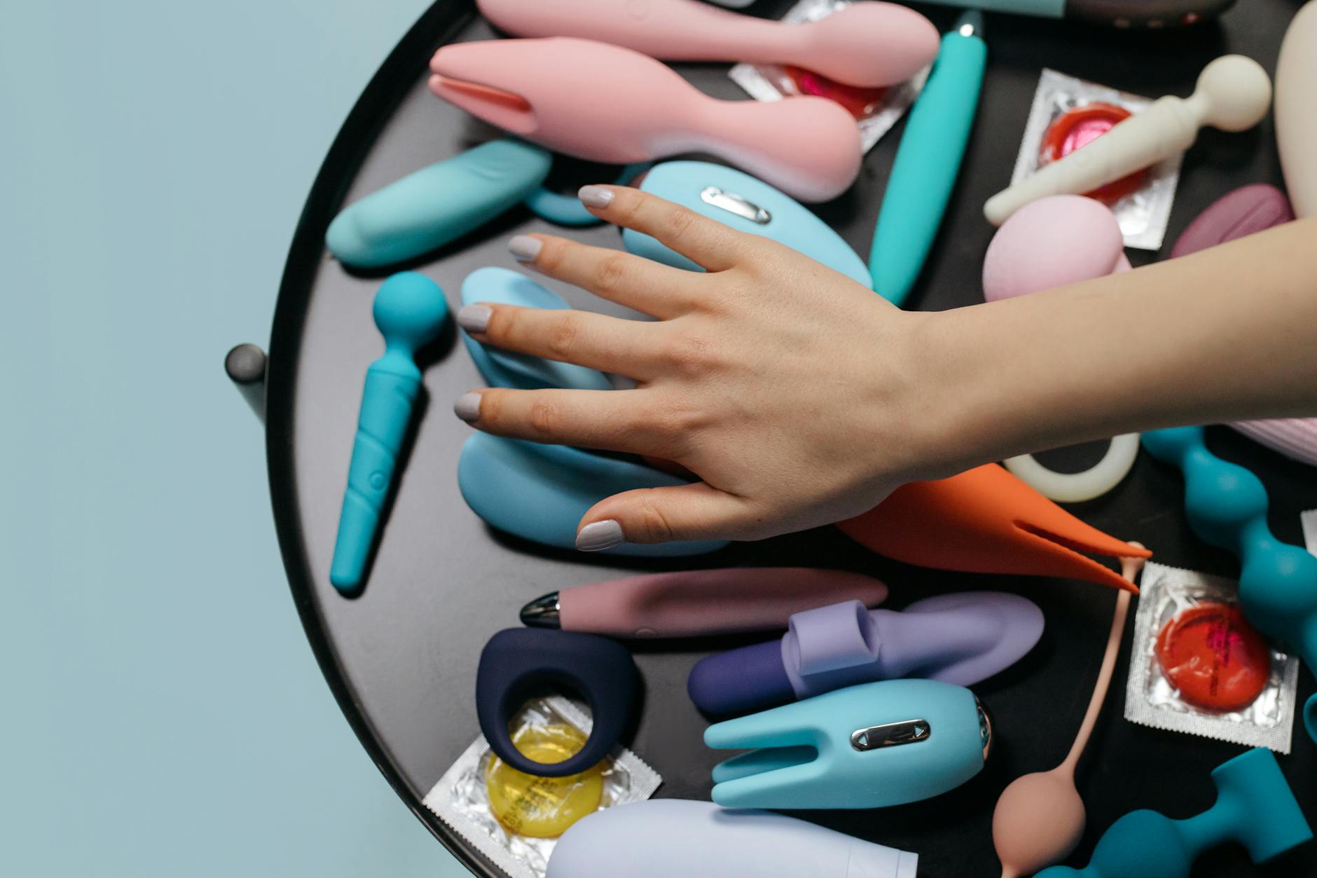 Person holding clitoral vibrators while considering treatment options for medication-related sexual side effects